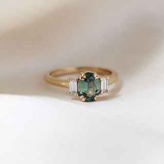 Trilogy Oval Green Sapphire Ring quarter view on fabric