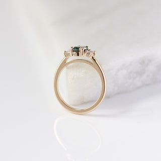 Trilogy Oval Green Sapphire Ring profile side view on marble