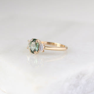 Trilogy Oval Green Sapphire Ring quarter side view on marble