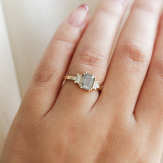 Emerald cut salt and pepper diamond ring in yellow gold on hand