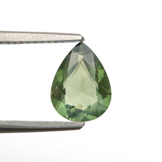 Green double cut pear sapphire in tweezers