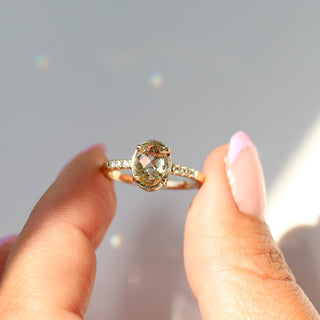  Oval Champagne Salt & Pepper Diamond Ring in sunlight being held in a hand