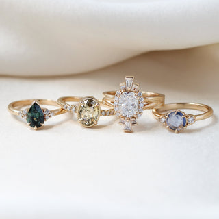  Oval Champagne Salt & Pepper Diamond Ring paired with green and blue sapphire rings and a large Ballerina ring 