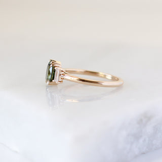 Oval Cut Green Sapphire Ring side view on marble