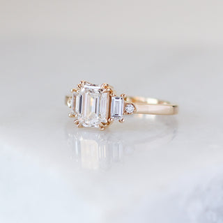Emerald cut lab diamond ring with baguette and round brilliant cut side stones in yellow gold, quarter view