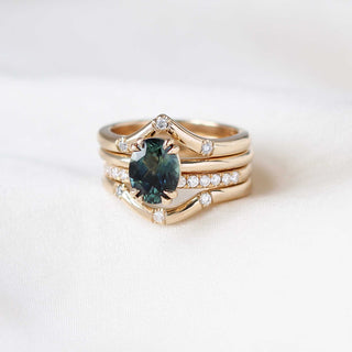 Teal oval sapphire solitaire ring with gold stacking rings