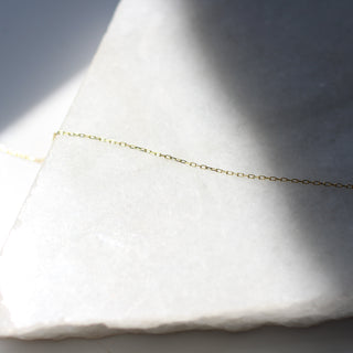 Paper Clip Chain in sunlight on marble detailed view