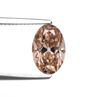 Champagne oval old mine cut lab created diamond in tongs