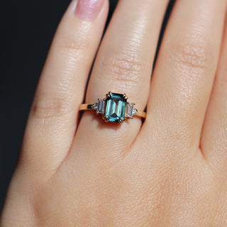 Emerald Cut Teal Sapphire Ring in sunlight worn on hand