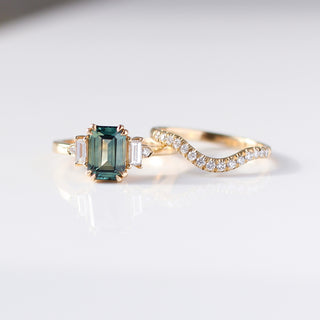 Emerald Cut Teal Sapphire Ring paired with diamond gold band detail front view