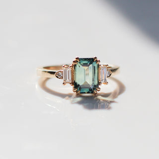 Emerald Cut Teal Sapphire Ring in sunlight quarter view