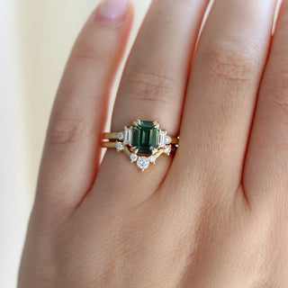 Misceo Emerald Cut Green Sapphire Ring paired with diamond gold ring being worn on hand detailed front view