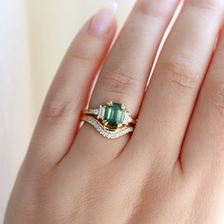 Misceo Emerald Cut Green Sapphire Ring paired with wave diamond gold band worn on hand in sunlight front view