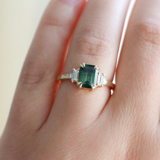 Emerald cut green sapphire ring on hand 