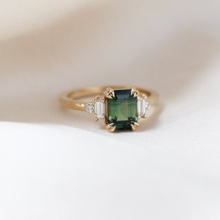 Misceo Emerald Cut Green Sapphire Ring front view on fabric