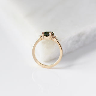 Misceo Emerald Cut Green Sapphire Ring profile side view on marble