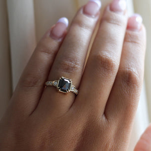 Square cut black diamond ring in yellow gold on hand