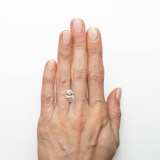 White oval brilliant cut lab created diamond on hand
