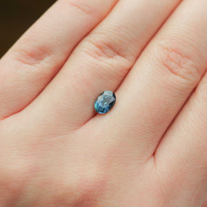 Oval shaped teal sapphire on hand