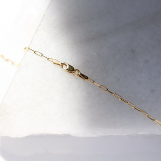 Paper Clip Chain lock in sunlight on marble detailed front view