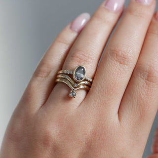 Three diamond chevron band in gold ring stack on hand