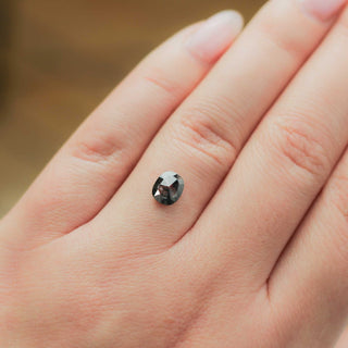 Cushion shaped salt and pepper diamond on hand