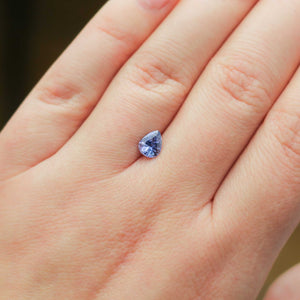 Pear shaped purple sapphire on hand