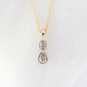 Emerald cut and pear diamond necklace front view 