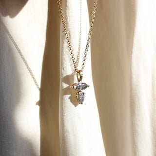 Marquise and pear cut diamond necklace in yellow gold in sun light 