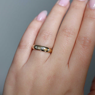 Domed diamond ring on hand