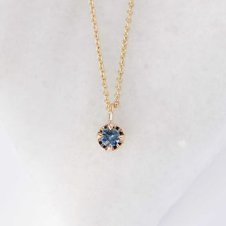 Blue sapphire necklace in yellow gold front view