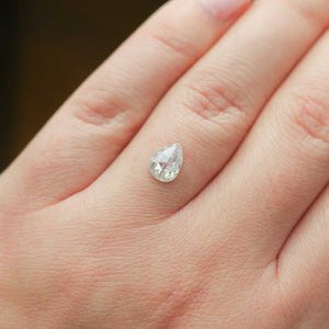 Pear shaped icy salt and pepper diamond on hand