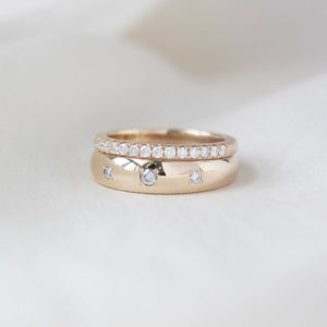 Domed diamond band in gold ring stack