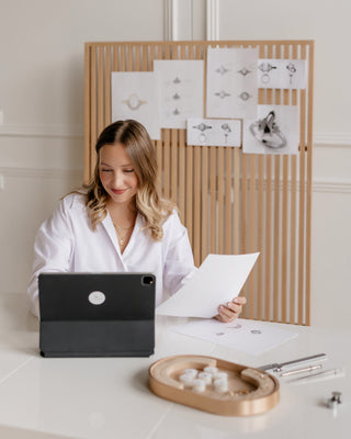 Founder Yuliya Chorna reviewing custom ring designs at her studio in Toronto.