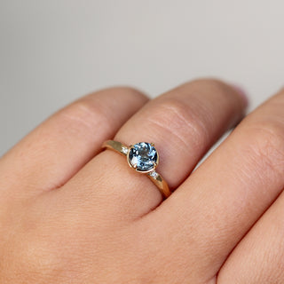 Round blue spinel ring in yellow gold, on hand quarter view