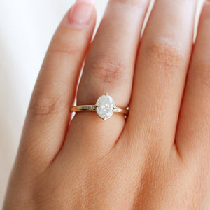 Oval diamond ring on finger