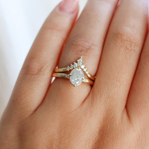 Oval diamond ring with diamond chevron band on hand