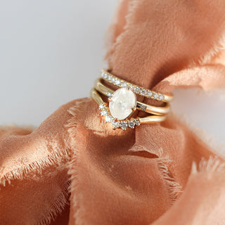 Oval diamond ring with diamond bands on fabric