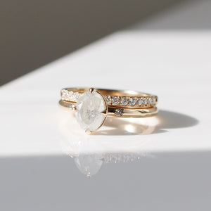 Oval diamond ring with diamond band in sunlight