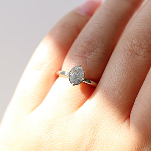 Oval grey diamond ring on hand in sunlight