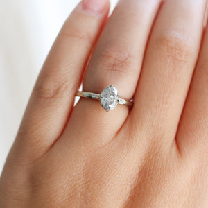 Oval grey diamond ring on finger