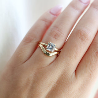 Asscher Cut Sapphire Ring paired with wave gold band being worn