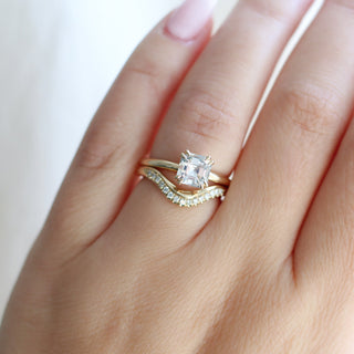 Asscher Cut Sapphire Ring paired with wave diamond gold band being worn on hand