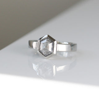 Custom engagement ring with ethically sourced hexagon cut diamond centre stone in a silver setting, handcrafted by Yuliya Chorna at her Toronto studio.