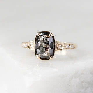 Custom engagement ring with ethically sourced black diamond centre stone in a gold setting, with diamond accents.