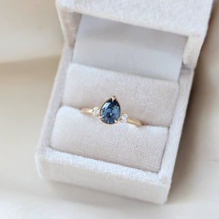 Pear blue sapphire engagement ring in ring box