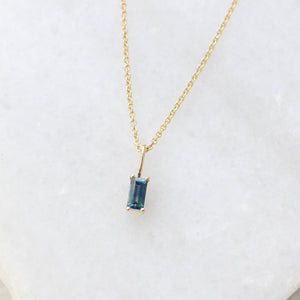 Blue Sapphire Baguette Cut Pendant on chain  on marble