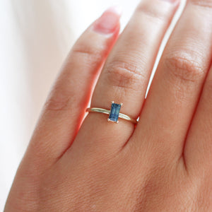 Teal blue sapphire ring on hand