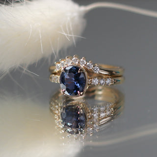 Custom pointed wedding band and engagement ring set with ethically sourced diamonds and sapphire in a gold setting, handcrafted by Yuliya Chorna at her Toronto studio.