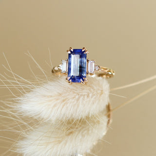 Custom engagement ring with ethically sourced sapphire centre stone in a gold setting, handcrafted by Yuliya Chorna at her Toronto studio.